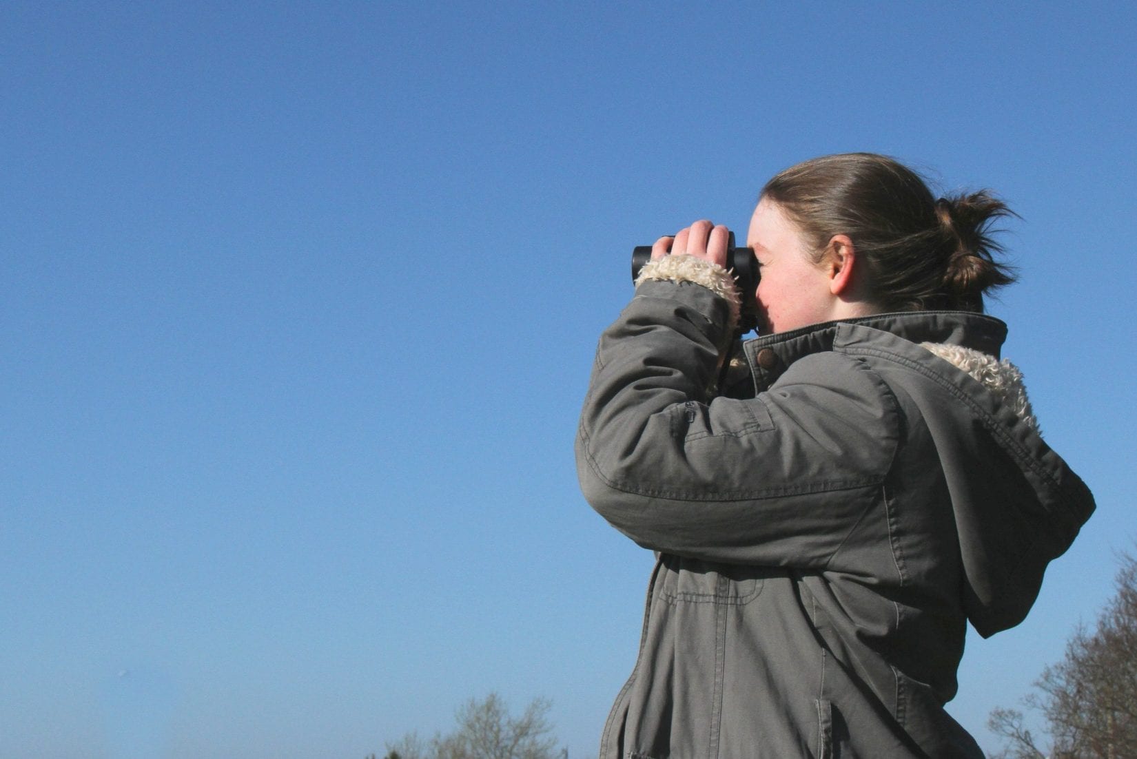 Girl-looking-through-binoculars