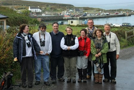 eight-people-with-binoculars-with-a-harbour-in-the-background