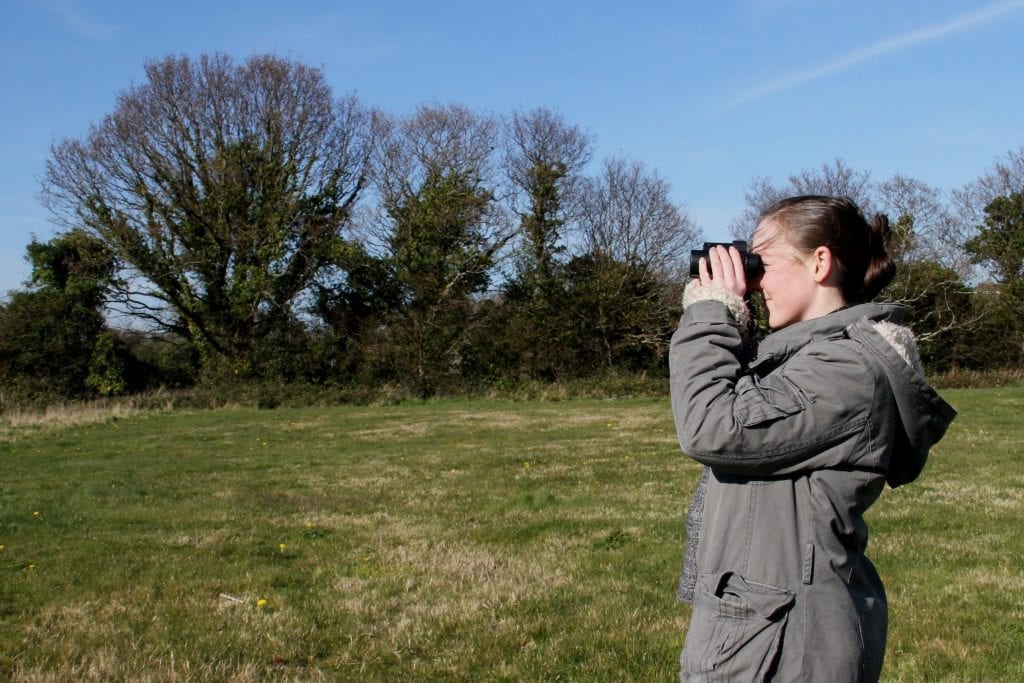 birdwatcher-in-field-with-opticron-binoculars
