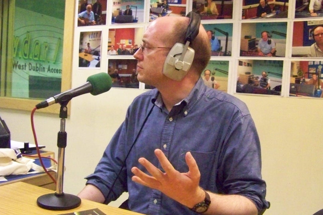 Niall Hatch wearing headphones in a radio studio