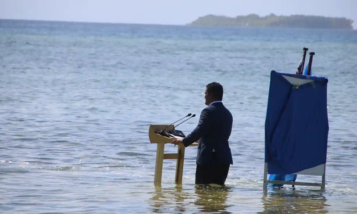 Tuvalu’s Foreign Minister Simon Kofe gives a COP26 statement while standing in knee-deep seawater. Photo: Tuvalu Foreign Ministry/Reuters
