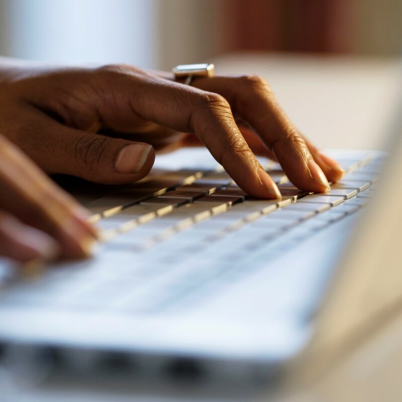 Side-profile-of-hands-typing-on-a-keyboard